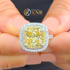 a person holding a fancy yellow diamond ring