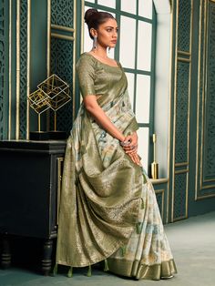 Introducing our exquisite off-white and olive green cotton saree, a perfect blend of traditional charm and contemporary elegance. This saree is crafted with meticulous attention to detail, featuring intricate digital print work that adds a modern touch to its classic design. The rich weaving pallu and the intricately designed weaving border enhance its regal appearance, making it a timeless piece suitable for any occasion. The soft cotton fabric ensures maximum comfort, allowing you to drape it Festive White Saree With Printed Motifs, Green Cotton Silk Saree With Printed Motifs, White Semi-stitched Saree With Printed Motifs, Green Saree With Digital Print For Diwali, Green Cotton Silk Saree With Printed Border, White Digital Print Saree For Wedding, Green Digital Print Saree For Wedding, Elegant White Saree With Printed Border, Festive White Saree With Digital Print