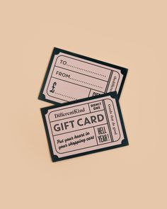 two black and white gift cards sitting on top of each other