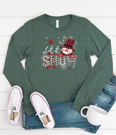 Get in the spirit of the Christmas season with this Let It Snow Snowman long sleeve graphic shirt. Perfect for Christmas morning or a day at the Christmas Tree Farm, or all winter long. This cute Christmas T-shirt is so adorable for your Christmas and winter festivities! Our shirts are great for the fall season and would make a great gift.  Are you looking for your new favorite t-shirt? Our graphic tees are custom created specifically for you and made by me not sourced out to a print shop. Selec Winter Long Sleeve Graphic Shirt, Winter Holiday Long Sleeve T-shirt, Festive Winter Shirt With Letter Print, Christmas Festive Long Sleeve Tops, Festive Long Sleeve Tops For Christmas, Winter Festive Long Sleeve Tops, Holiday Festive Long Sleeve Shirt, Festive Long Sleeve T-shirt For Holiday, Festive Long Sleeve Holiday T-shirt