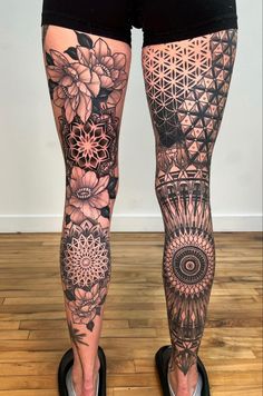 a woman's legs with tattoos on them and flowers in the middle of her leg