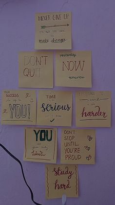 several pieces of paper that have been pinned to a wall with writing on them,