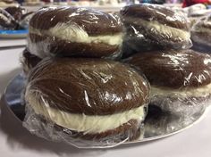 several chocolate desserts wrapped in plastic on a plate