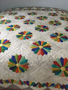 a colorful quilt on top of a bed