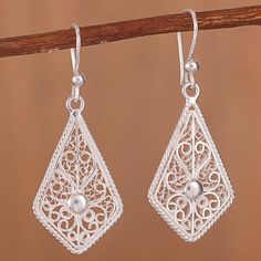 These exquisite dangle earrings showcase the delicate and intricate beauty of filigree. Peruvian artisan Alfredo Inga handcrafts these sterling silver earrings in a kite shape with a rope motif border and filigree scrolls connecting to a bead at the center. The earrings are polished to give them a brilliant look. Art Deco Drop Earrings, Silver Smithing, Filigree Hoop Earrings, Butterfly Earrings Gold, Filigree Bracelet, Filigree Jewelry, Dragonfly Earrings, Sterling Silver Filigree, Filigree Design