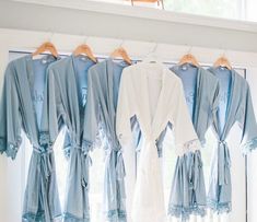 several robes hanging in front of a window