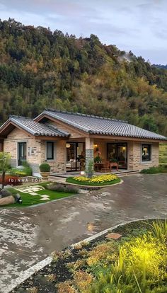 a small house in the middle of a lush green hillside