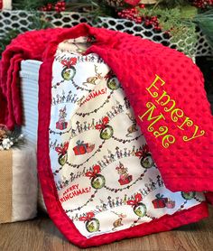 a red christmas tie sitting on top of a wooden table next to a gift bag