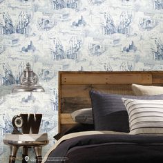 a bedroom with blue and white wallpaper in the background, along with a wooden headboard