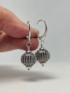 Sterling Silver Earrings Dangle. Leverback Earrings. These sterling silver Bali ball bead earrings are handmade. 12.3 mm wide, oxidized beads decorated with lines and granules are mounted with Euro-style leverback earring wires. The set is 1 1/2 inches (3.8 cm) in long. Pictures are enlarged to show detail. These are the lovely Bali sterling silver leverback earrings you will receive. Gift for Wife, Girlfriend Gift, Gift for Mom, Gift for Sister, Gift for Her, Gift for Women. The earrings ship in a small organza bag inside a gift box, ready to give... or keep! To see more WireAndPearl Sterling Silver Earrings, please visit: https://www.etsy.com/shop/WireAndPearl?section_id=18630564 Also, WireAndPearl Gold Filled and Vermail Earrings can be found here: https://www.etsy.com/shop/WireAndPearl Long Pictures, Birthday Gift For Women, Earring Wires, Ball Earrings, Bag Inside, Gift For Sister, Leverback Earrings, Euro Style, Girlfriend Gift