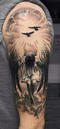 a man's arm with an angel tattoo on it and clouds in the background