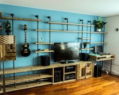 a living room filled with furniture and a flat screen tv on top of a wooden shelf