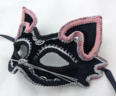 Black velour masquerade mask decorated with silver, and pink trims, glitter, whiskers, and cat ears.  It has a plastic base covered in black velour on the outside, and black felt on the inside for comfort. Ribbon ties. Not suitable for children under 3 years of age. Hand made in Australia. Laura Lucci Collection. NOTE: Shipment is via Australia Post, check their website at: https://auspost.com.au for estimated delivery times to your location. Masquerade Mask Women, Pink Mask, Moustaches, Venetian Mask, Masquerade Mask, Cat Costumes, Black Felt, Costume Party, Costume Accessories