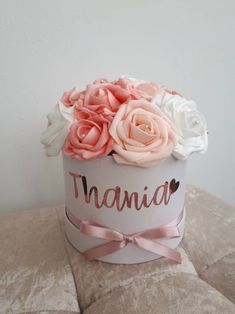 a white hat with pink and white flowers in it that says,'mama '