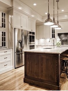 a large kitchen with an island in the middle