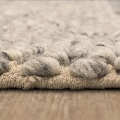 a close up view of a rug on the floor with wool flecks all over it