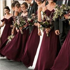 the bridesmaids are all dressed in maroon dresses