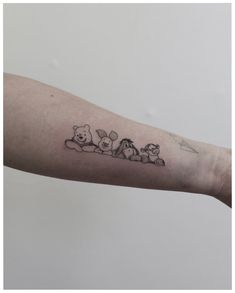 a person with a tattoo on their arm that has three bears and a dog in it