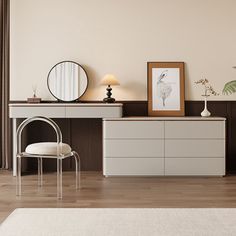 a room with a dresser, mirror and chair next to a large painting on the wall