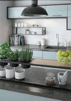 the kitchen counter is covered with bowls and fruit