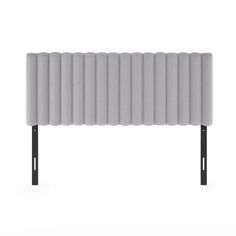 an upholstered headboard with black metal legs and grey fabric coverings on it