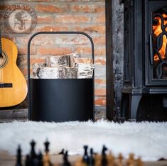 a fire place next to a guitar and some chess pieces