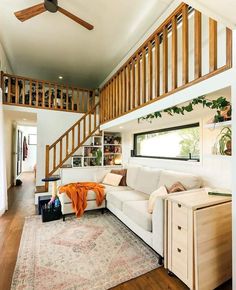 a living room filled with furniture and a stair case