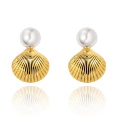 Complete your elegant look with our Sylvie Pearl Earrings. These stunning earrings feature a delicate pearl stud and a beautiful gold shell design, adding a touch of sophistication to any outfit. Perfect for any occasion, they make a great addition to your jewelry collection. 18k Gold Plated over Stainless Steel 1.1" Hypoallergenic Water & Tarnish Resistant Elegant Shell-shaped Pearl Earrings, Elegant Shell Pearl Earrings For Gift, Elegant Shell-shaped Pearl Earrings For Wedding, Elegant Shell With Pearl Charm, Elegant Shell Drop Earrings As Gift, Elegant Shell Drop Earrings For Gift, Elegant Shell Earrings For Gifts, Elegant Drop Shell Earrings As A Gift, Elegant Pearl Shell With Pearl Drop