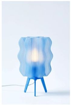 a blue lamp sitting on top of a table