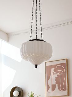 a white lamp hanging from a ceiling in a living room