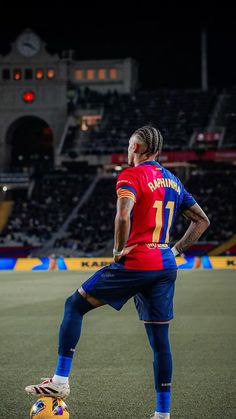 a man standing on top of a field next to a soccer ball