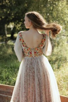 the back of a woman's dress, with her hair flying in the wind