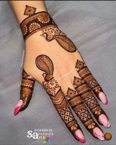 a woman's hand with henna tattoos on it