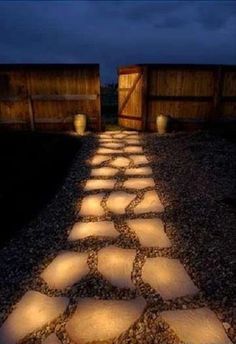 an iphone screenshot of a path with rocks painted in glow in the dark during the day