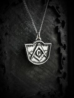 This Square and compasses necklace is an handmade pewter sculpture of my own creation, it is inspired by a gravestone at Elmwood Cemetery (Sherbrooke, Canada)The square and compass is commonly associated to the freemasonry, the meaning is debated and may change between individuals and cultures. The letter G is sometimes associated with the G from God, while Eliphas Levi associate it with Great Architect. This necklace is 24mm x 27mm This square and compass Pendant is sold with a 18'' or 24'' sta Symbolic Pewter Jewelry As Gift, Symbolic Pewter Jewelry For Gifts, Engraved Pewter Jewelry Gift, Symbolic Pewter Jewelry With Adjustable Fit, Symbolic Stamped Medallion Jewelry, Symbolic Antique Silver Medallion Jewelry, Symbolic Antique Silver Nickel-free Jewelry, Engraved Pewter Round Pendant Jewelry, Stamped Silver Brass Jewelry