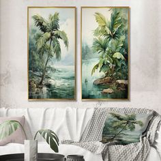 two paintings hanging on the wall above a couch