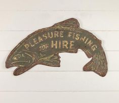 a metal sign that says pleasure fishing for hire