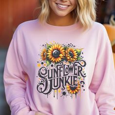 Cozy sweatshirt for women featuring the saying 'sunflower junkie'. Perfect for lounging at home or running errands during the colder months. Ideal for women who love sunflowers and enjoy comfortable clothing. Relevant for holidays like Thanksgiving and Christmas. Product features - Made with 50% cotton and 50% polyester for a cozy feel in colder weather - Ribbed knit collar for elasticity and shape retention - Classic fit with crew neckline for a comfy wearing experience - Double-needle stitching for added durability - Ethically made with US-grown cotton and environmentally friendly dyes Care instructions - Machine wash: cold (max 30C or 90F) - Non-chlorine: bleach as needed - Tumble dry: low heat - Do not iron - Do not dryclean Yellow Long Sleeve Tops With Sunflower Print, Yellow Long Sleeve Top With Sunflower Print, Fall Crew Neck Top With Sunflower Print, Relaxed Fit Crew Neck Top With Sunflower Design, Relaxed Fit Sunflower Crew Neck Top, Thanksgiving And Christmas, Comfy Sweater, Sweatshirt For Women, Comfy Sweaters