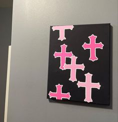 a black and pink wall with crosses painted on it