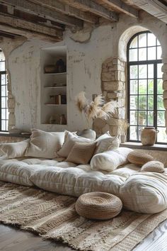 a living room filled with lots of furniture and windows