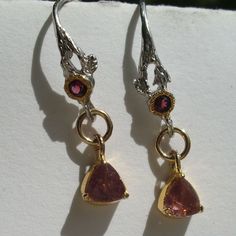 "I used the following materials for the earrings: Gemstone - Faceted tourmalines (top quality: almost clear and in a lovely pink. They come from Brazil, have only been polished and have a very, very good brilliance - they glitter much more beautifully than it may appear in the pictures) - faceted garnets (very good quality: only polished, faceted and in a beautiful red pink) Recordings were under sunlight metal - Gold wreath: \"gold filled\" - Remaining metal elements: 925 sterling silver - part Pink Sapphire Jewelry Set With Matching Earrings, Unique Pink Ruby Jewelry, Pink Ruby Earrings For Anniversary, Pink Dangle Earrings With Prong Setting, Unique Pink Sterling Silver Earrings, Pink Ruby Dangle Jewelry, Unique Pink Gemstone Earrings, Pink Sterling Silver Birthstone Earrings, Pink Birthstone Earrings In Sterling Silver