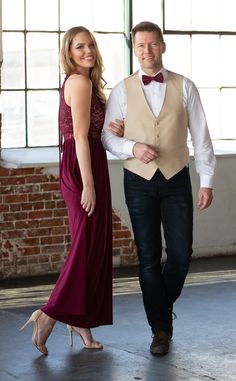 a man and woman in formal wear standing next to each other