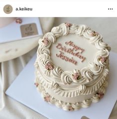 a birthday cake with white frosting and pink flowers