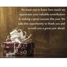 a gift box with a white ribbon on it and the words, we want you to know how much much we appreciate your valuable condition in making a great success this year