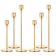 four gold candlesticks are lined up in a row