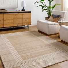 a living room with two chairs and a rug