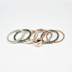 This is a set of 7 stackable rings,made of sterling silver wire 925 then soldered and 1 of them hammered.One ring has a heart with the initial of your own choice All stacking rings have a beautiful shinny finish but i can change that If you want. 2 rings are made from rose gold plated sterling silver, 2 are from black rhodium plated sterling silver and the rest 3 are from sterling silver 925. 2 ring are made from rectangle wire 1.5mm (1 silver and one rose gold plated) 2 rings is made from multi Stackable Rings Gold, Initial Rings, Gold Stacking Rings, Sterling Silver Stackable Rings, Stack Rings, Stackable Ring Sets, Stackable Rings Silver, 2 Rings, Stacking Ring Set