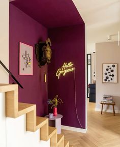 there is a purple wall and stairs in the room