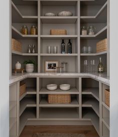 a kitchen with lots of shelves filled with dishes