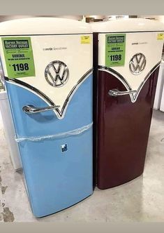 two refrigerators with stickers on them sitting side by side in a store display